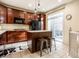 Beautiful kitchen with dark wood cabinets, black appliances, and a cozy breakfast bar at 1057 3Rd Nw Ave, Carmel, IN 46032