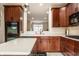 Modern kitchen features dark wood cabinetry, white countertops, and stainless steel appliances at 1057 3Rd Nw Ave, Carmel, IN 46032