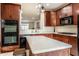 Gourmet kitchen featuring an island, stainless steel appliances, and dark wood cabinetry at 1057 3Rd Nw Ave, Carmel, IN 46032