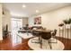 Open-concept living area featuring hardwood floors, a dining table, and a comfortable seating area at 1057 3Rd Nw Ave, Carmel, IN 46032