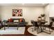 Cozy living area featuring a comfortable gray sofa, wooden coffee table, and dining area at 1057 3Rd Nw Ave, Carmel, IN 46032