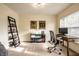 Well-lit home office with a large window, built-in shelving, and a comfortable desk setup at 1057 3Rd Nw Ave, Carmel, IN 46032