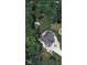 Overhead shot of house and yard with a large surrounding of trees at 1066 N Dogwood Way, Greenfield, IN 46140