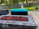Backyard scene showing comfortable outdoor seating around a modern rectangular firepit feature at 1066 N Dogwood Way, Greenfield, IN 46140