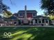 A well manicured backyard with a large deck, a grill and smoker, and lots of outdoor seating at 1066 N Dogwood Way, Greenfield, IN 46140