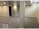 A basement rec room with neutral paint and gray carpeting at 1066 N Dogwood Way, Greenfield, IN 46140