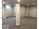Neutral basement has carpet and bright lights at 1066 N Dogwood Way, Greenfield, IN 46140