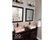 Stylish bathroom featuring double stone vessel sinks, modern fixtures, and decorative lighting at 1066 N Dogwood Way, Greenfield, IN 46140