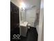 Bathroom with a modern vanity, dark floors, tiled shower, and updated fixtures at 1066 N Dogwood Way, Greenfield, IN 46140