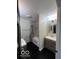 Bathroom with tile surround, modern fixtures and dark wood flooring at 1066 N Dogwood Way, Greenfield, IN 46140
