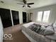 Bedroom with a comfortable bed, a bright window and multiple dark closets at 1066 N Dogwood Way, Greenfield, IN 46140