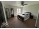 Bedroom with a comfortable bed, dark wood dresser and a bright window at 1066 N Dogwood Way, Greenfield, IN 46140