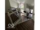 Bright entryway with a staircase featuring white railings and dark iron spindles at 1066 N Dogwood Way, Greenfield, IN 46140