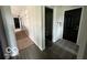 View of the entryway, with a black front door, hallway leading to bedrooms and powder room at 1066 N Dogwood Way, Greenfield, IN 46140