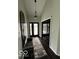 Well-lit entryway with dark wood floors, a decorative mirror, and a bench at 1066 N Dogwood Way, Greenfield, IN 46140