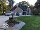 Inviting brick two-story home with a well-manicured lawn and a spacious driveway showcasing curb appeal at 1066 N Dogwood Way, Greenfield, IN 46140