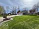 Charming front exterior view featuring a spacious lawn, two-car garage, and a large driveway at 1066 N Dogwood Way, Greenfield, IN 46140