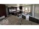 Well-equipped kitchen featuring dark wood cabinetry, granite countertops, a breakfast nook, and stainless steel appliances at 1066 N Dogwood Way, Greenfield, IN 46140