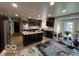 Modern kitchen with stainless steel appliances, a center island with a cooktop, and lots of natural light at 1066 N Dogwood Way, Greenfield, IN 46140