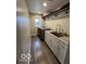Laundry room featuring a sink, washer, dryer, white cabinetry and wood look tile flooring at 1066 N Dogwood Way, Greenfield, IN 46140