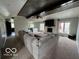 Bright living room showcasing a beamed ceiling, a brick fireplace, large windows, and a comfortable sectional sofa at 1066 N Dogwood Way, Greenfield, IN 46140