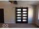 Main bedroom featuring a barn door leading to bathroom, ceiling fan and carpeted flooring at 1066 N Dogwood Way, Greenfield, IN 46140
