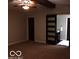 Main bedroom featuring a barn door leading to bathroom, ceiling fan and carpeted flooring at 1066 N Dogwood Way, Greenfield, IN 46140