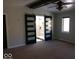 Main bedroom featuring a barn door leading to bathroom, ceiling fan and carpeted flooring at 1066 N Dogwood Way, Greenfield, IN 46140