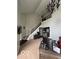 Inviting home office with a staircase, a large desk with a modern display, and a decorative chandelier at 1066 N Dogwood Way, Greenfield, IN 46140