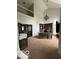 Spacious home office with a large desk and shelving, featuring a dramatic chandelier and abundant natural light at 1066 N Dogwood Way, Greenfield, IN 46140
