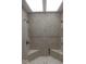 Spacious shower featuring decorative tilework, multiple showerheads, and built-in seating at 1066 N Dogwood Way, Greenfield, IN 46140