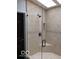 Modern tiled shower with a glass door, sleek fixtures, and a built-in niche for toiletries at 1066 N Dogwood Way, Greenfield, IN 46140