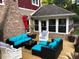 Charming sunroom extension off the wooden deck provides an ideal spot for relaxation and enjoying the outdoors at 1066 N Dogwood Way, Greenfield, IN 46140