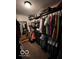 Spacious walk-in closet with dark wood shelving, clothing racks, and plenty of storage space at 1066 N Dogwood Way, Greenfield, IN 46140
