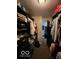 Large walk-in closet with dark wood organizers and shelving, perfect for clothing storage and organization at 1066 N Dogwood Way, Greenfield, IN 46140