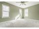 Bedroom with plush carpeting, neutral colored walls, ceiling fan, and three windows at 10775 Northhampton Dr, Fishers, IN 46038