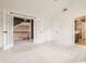 Upstairs bonus room featuring large doors, plush carpet, and lots of light at 10775 Northhampton Dr, Fishers, IN 46038