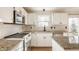 Kitchen featuring stainless steel appliances, granite countertops, white cabinetry, and modern faucet at 10775 Northhampton Dr, Fishers, IN 46038