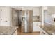 Bright kitchen with stainless steel refrigerator, granite counters, and white cabinetry at 10775 Northhampton Dr, Fishers, IN 46038