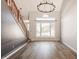Bright living room featuring hardwood floors, large windows, and decorative chandelier at 10775 Northhampton Dr, Fishers, IN 46038