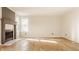 Cozy living room with a fireplace, hardwood floors, and lots of natural light at 10775 Northhampton Dr, Fishers, IN 46038