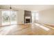 Spacious living room with fireplace, hardwood floors, and sliding glass doors at 10775 Northhampton Dr, Fishers, IN 46038