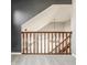 An upstairs staircase with wooden railing and neutral colored walls at 10775 Northhampton Dr, Fishers, IN 46038