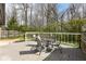 Backyard deck with table and chair set, overlooking wooded backyard at 10839 Cedar Pine Dr, Indianapolis, IN 46235