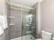Modern bathroom featuring tiled shower with glass door, and sleek fixtures at 10839 Cedar Pine Dr, Indianapolis, IN 46235