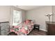 Bright bedroom featuring a window, modern fixtures, and warm neutral paint at 10839 Cedar Pine Dr, Indianapolis, IN 46235