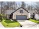Attractive home with a gray two-car garage, a brick facade, and green landscaping at 10839 Cedar Pine Dr, Indianapolis, IN 46235