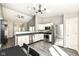 Bright kitchen with white cabinets, stainless steel appliances and an adjacent dining area at 10839 Cedar Pine Dr, Indianapolis, IN 46235