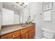 Bathroom with wooden cabinetry, a large mirror, and a shower/tub combo, designed for comfort and functionality at 110 Washington St # 301, Indianapolis, IN 46204