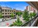 Balcony view of a tree-lined city street with buildings and vehicles at 110 Washington St # 301, Indianapolis, IN 46204